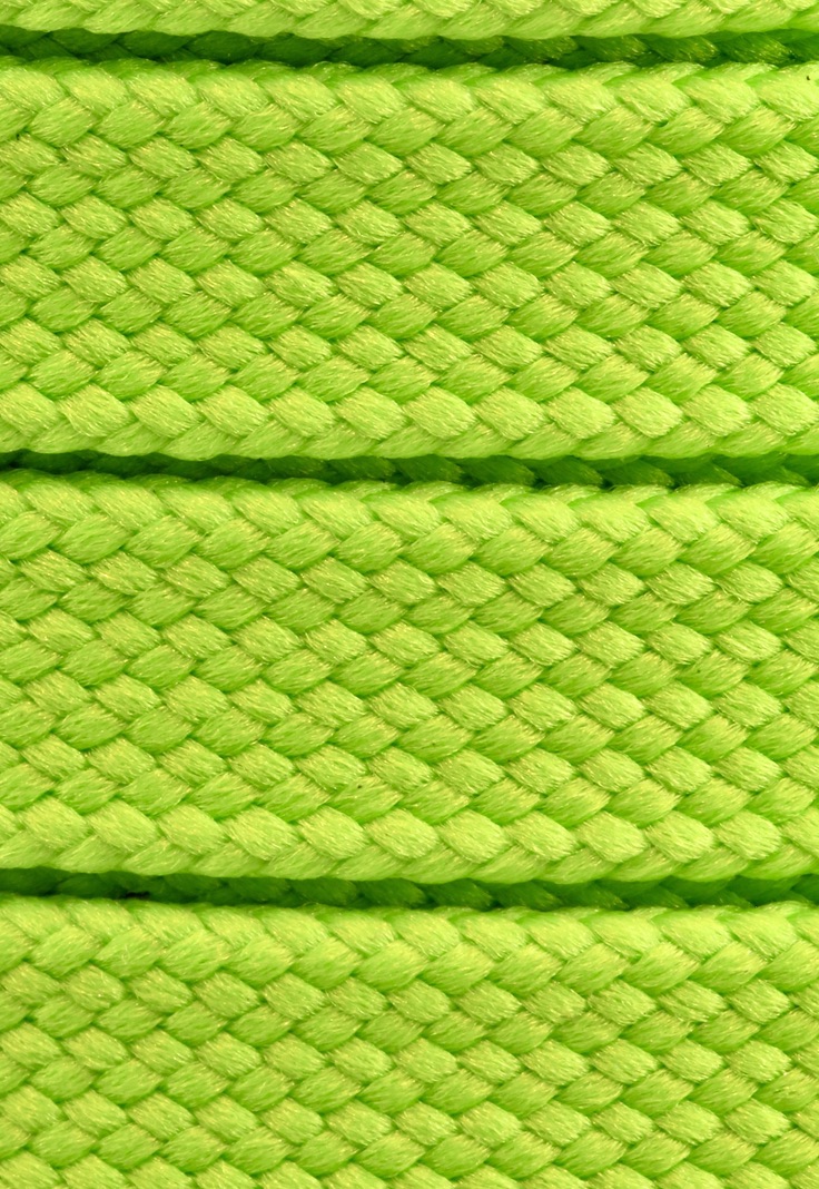 Macrophotography of bright green woven cord showing the structure of the weave