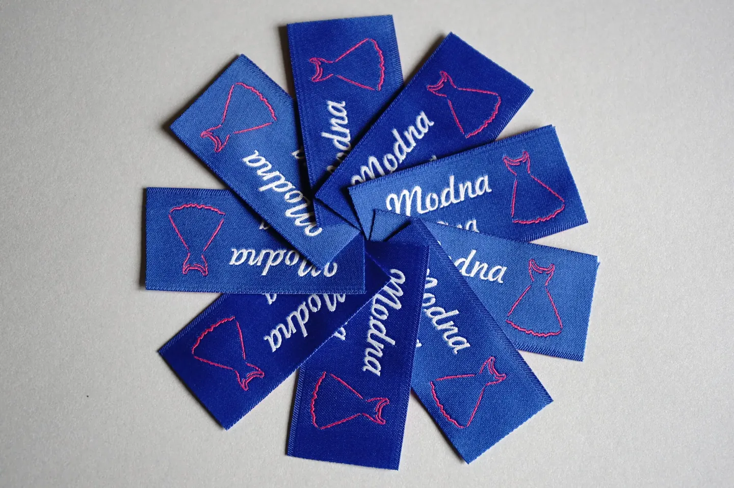 Blue emblems jacquard textile with colour inscription