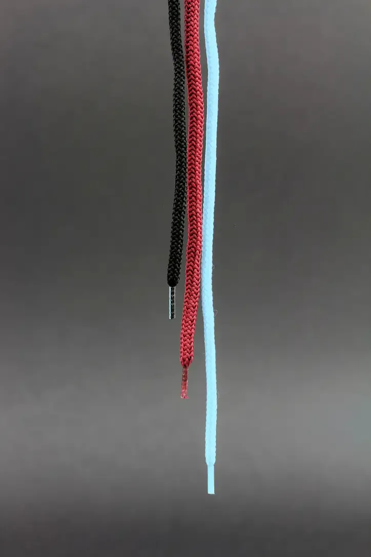 Three thin cord round in black, red and blue