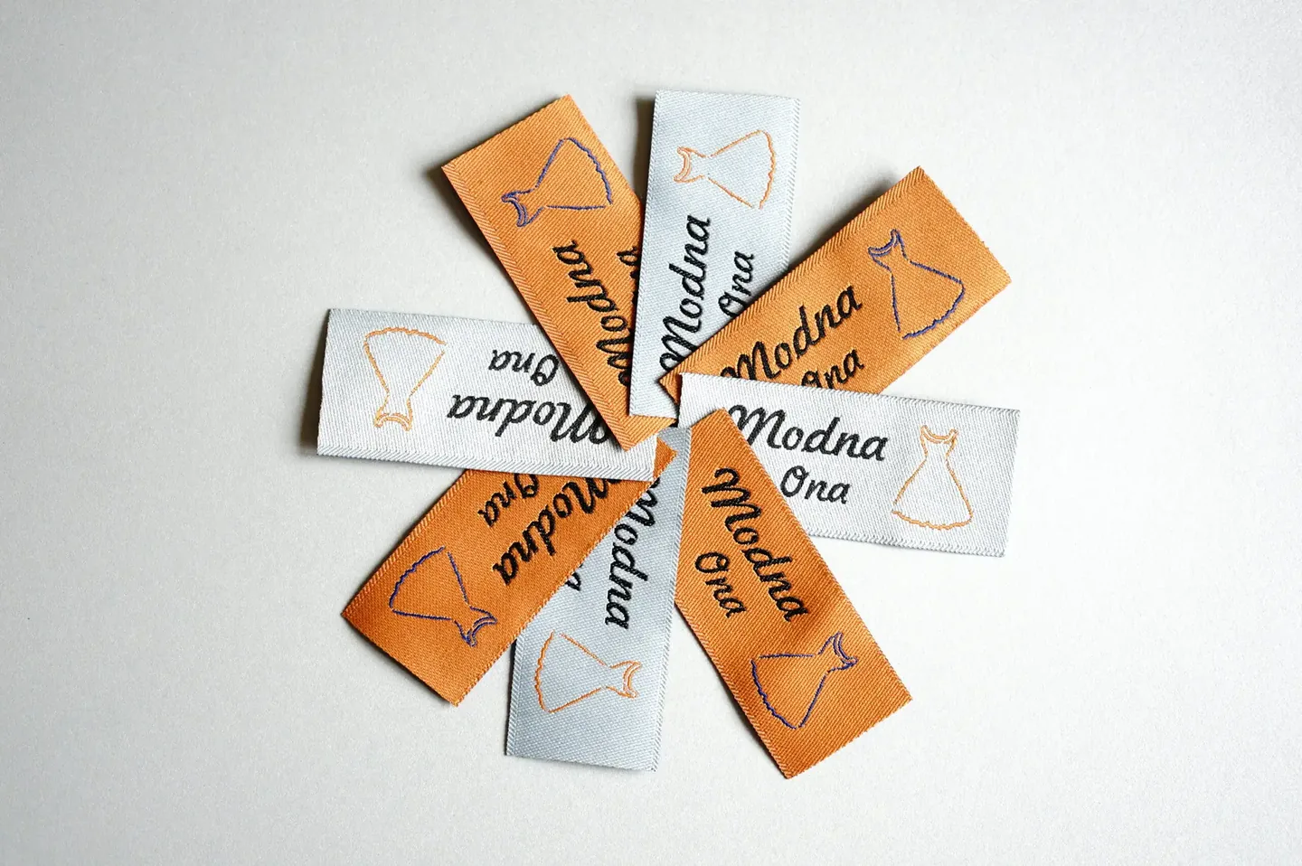 White and orange woven jacquard label in standard variant
